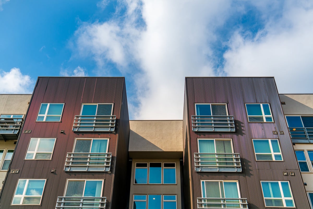 Luxury condominium exterior with glazing and blue sky